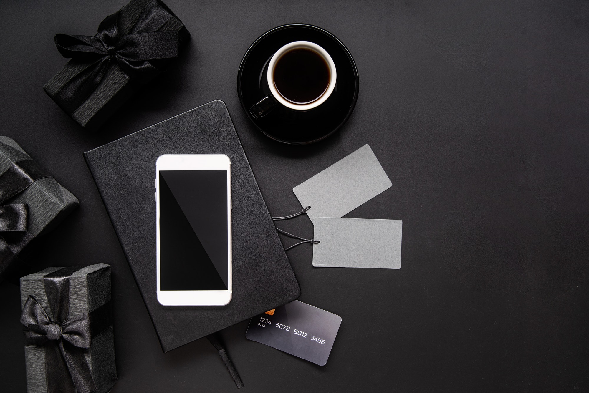 black-smartphone-price-tags-coffee-and-gifts-top-view-on-black-background.jpg